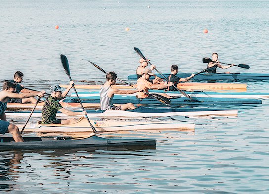 Group canoeing on a lake.